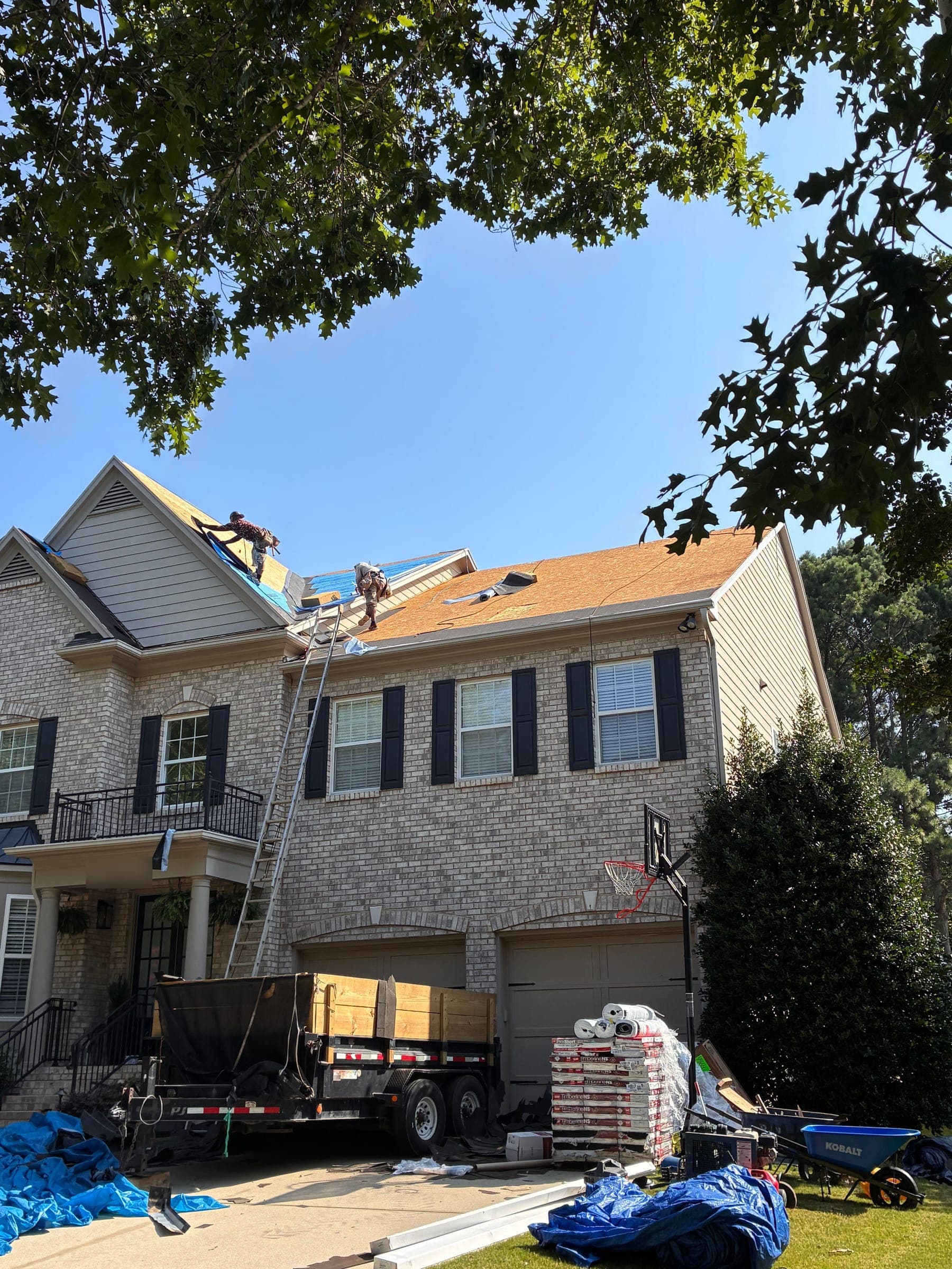 Megalo crew tearing off an old roof down to the deck
