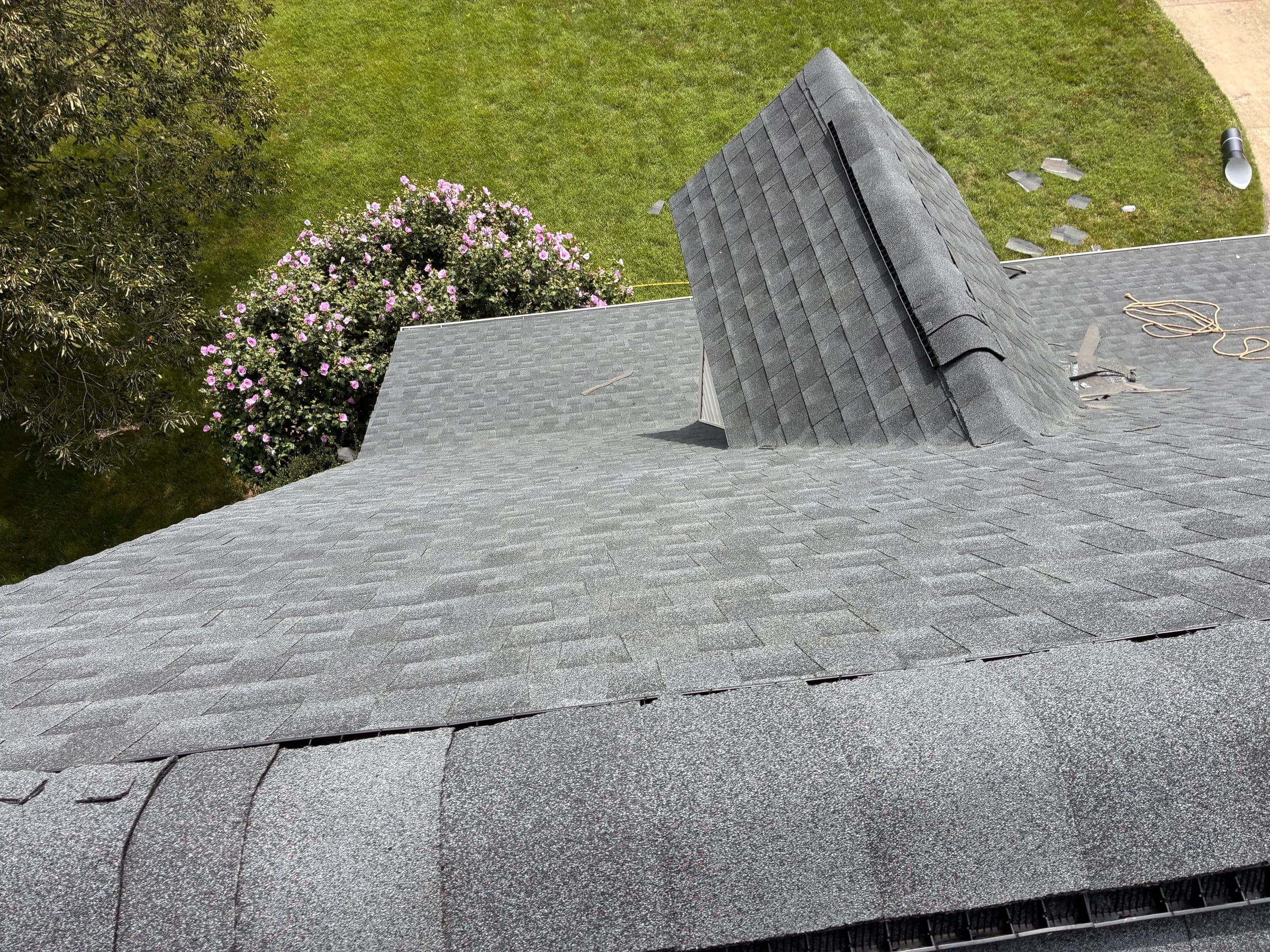 The same dormer finished in gray architectural shingles