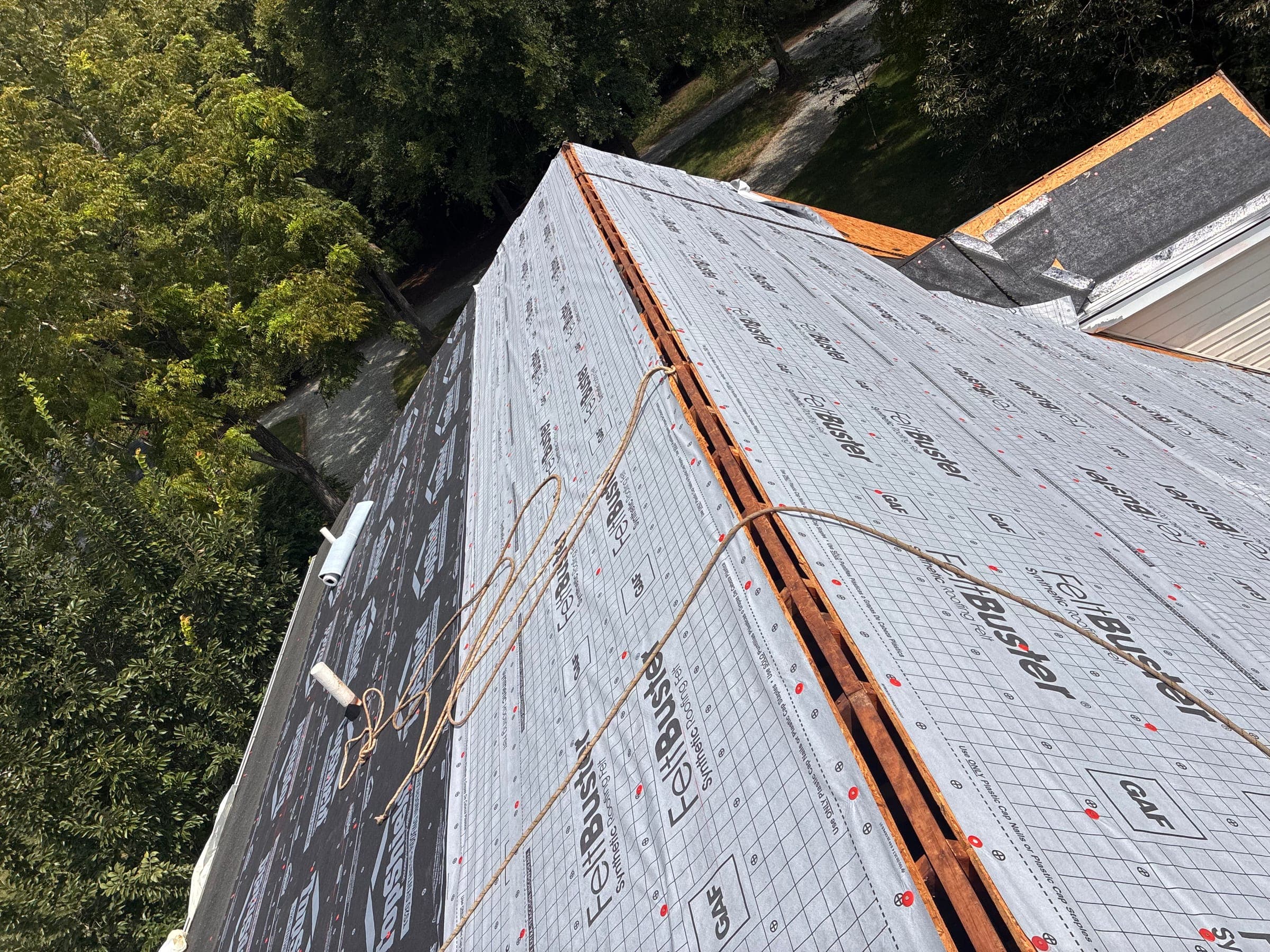Roof ridge with the vent slot cut open over new underlayment